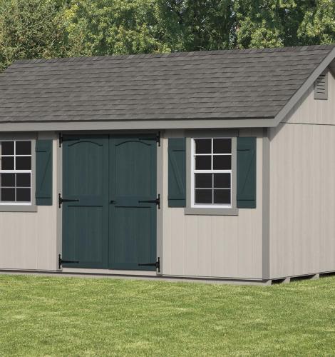 painted classic cottage shed with tan siding and green shutters and doors
