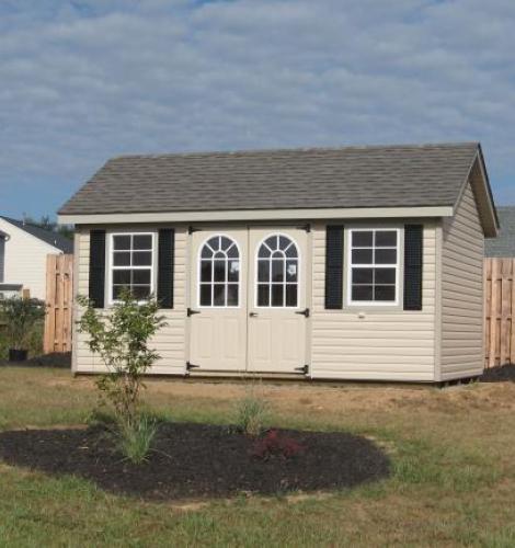 vinyl classic garden cottage with cream siding and black shutters