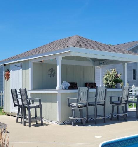 12x14 Hip-Roof Cabana with key lime green wood siding, white trim, and a bar with chairs.