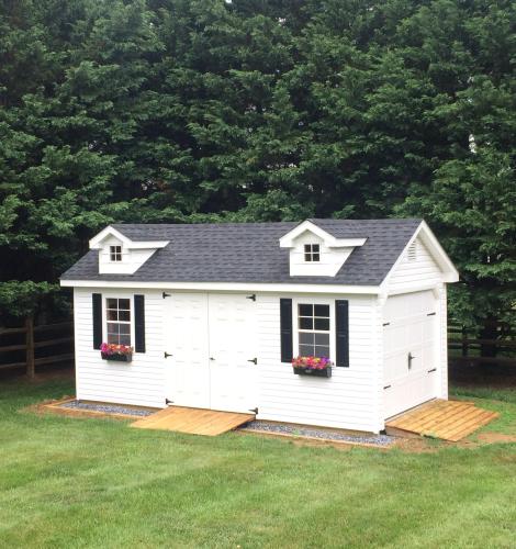 White shed with 2 ramps on a prepared foundation