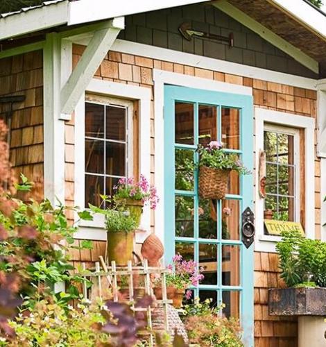Wooden shed surrounded by greenery