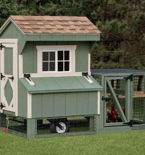 Green Quaker Chicken Coop with white trim, a raise coop, a fence in chicken run, windows, a door, a brown shingle roof, and wheels for transporting.