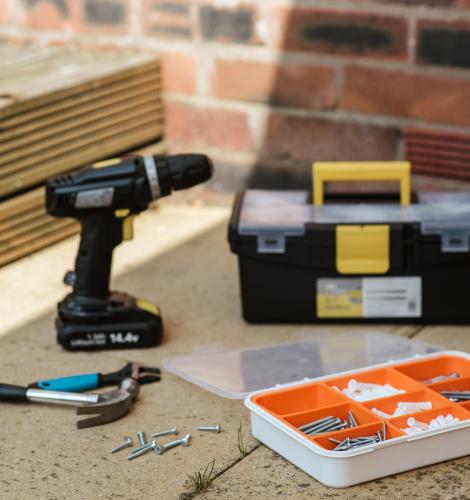 Tools and tool box sitting on ground.