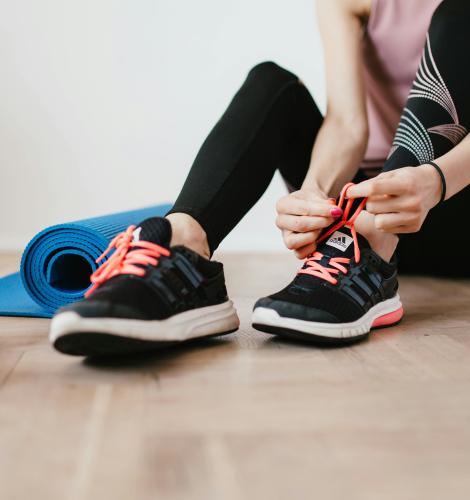 woman tying up her sneakers