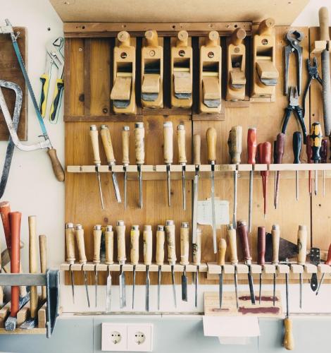 Assortment of tools hung on a tool rack