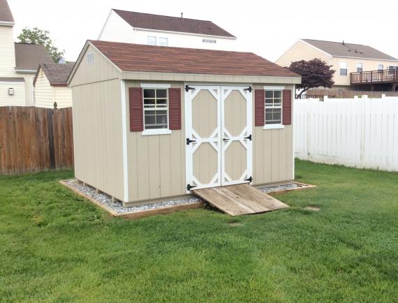 tan cottage shed with ramp