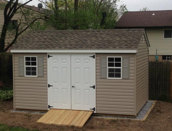 tan cottage shed with ramp