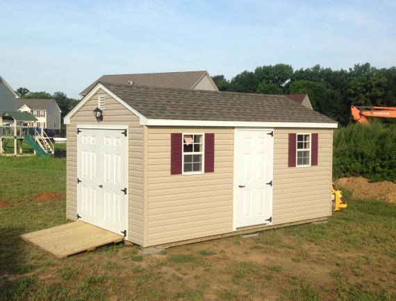 tan cottage shed with ramp