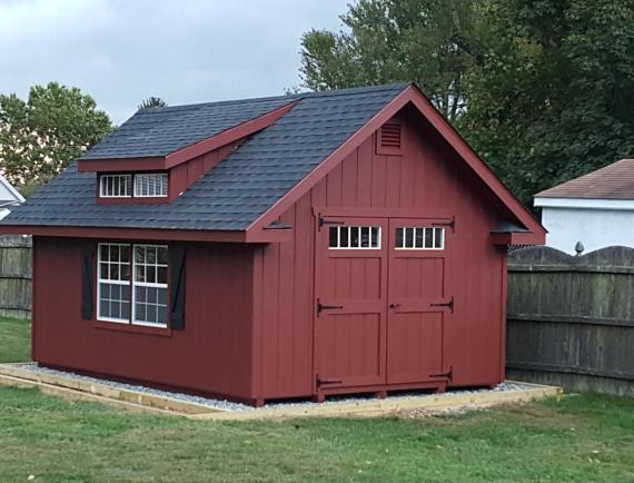 deluxe classic cottage with red siding and a dormer