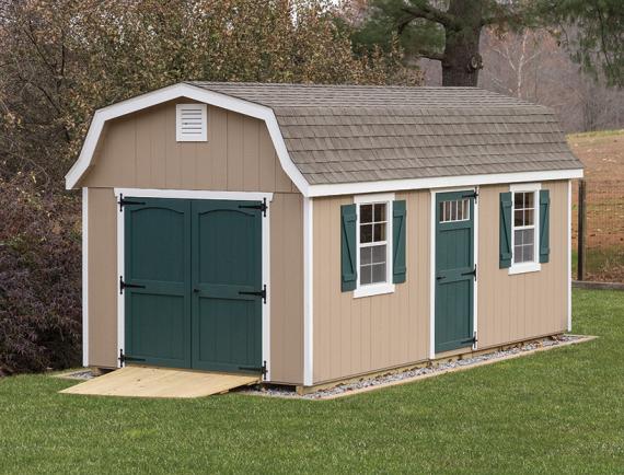 classic garden dutch barn shed with tan siding and green doors and shutters