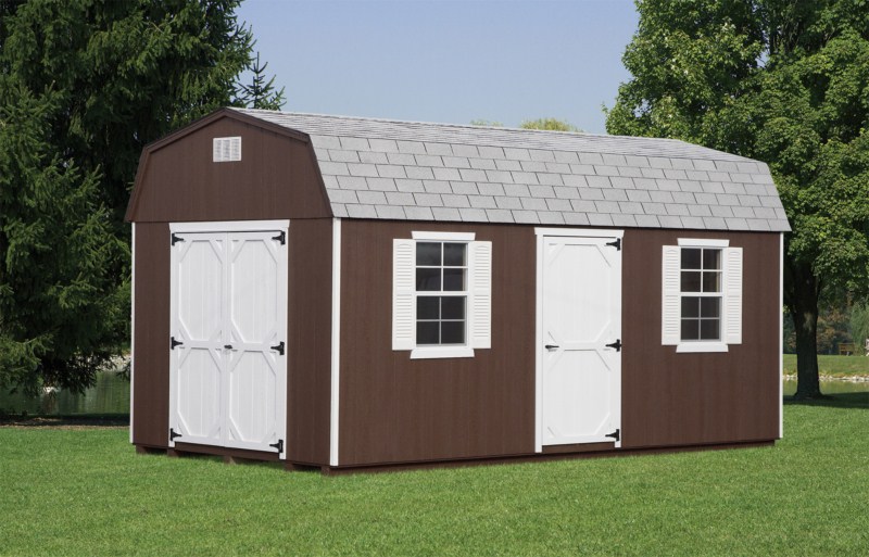dutch barn shed with brown siding and white doors and shutters