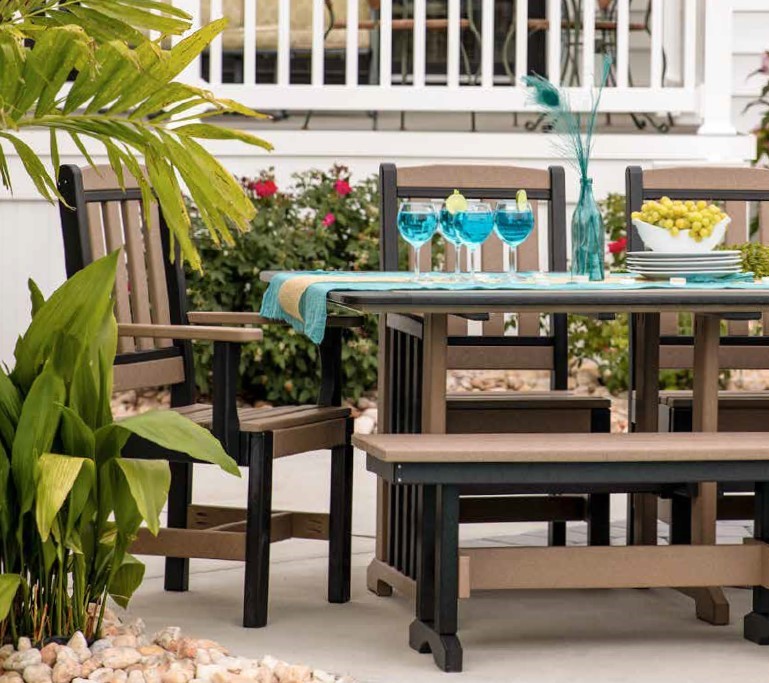 Brown and black poly furniture dining table and chairs set with a blue table runner and a set table.