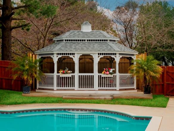White octagon closed in gazebo with gray roof and a white and gray cupola.