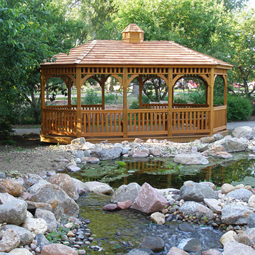 Brown oval wood gazebo near a small pond